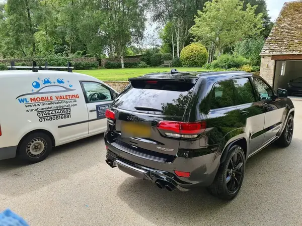 Black Jeep Grand Cherokee Trackhawk next to the WL Mobile Valeting van.
