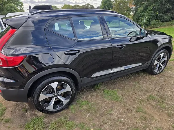 Black Volvo XC40 parked on grass after a valet.