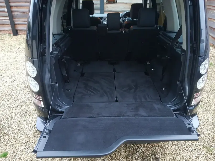 The boot of a black Land Rover Discovery after a valet, with the tailgate open.