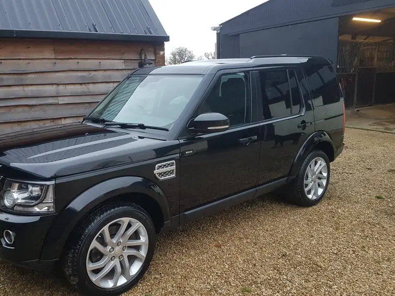 The same Discovery after the valet: clean black paint, bright wheels