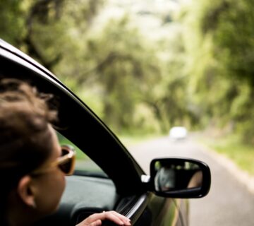 get your car ready for summer. Man looking outside of his car window