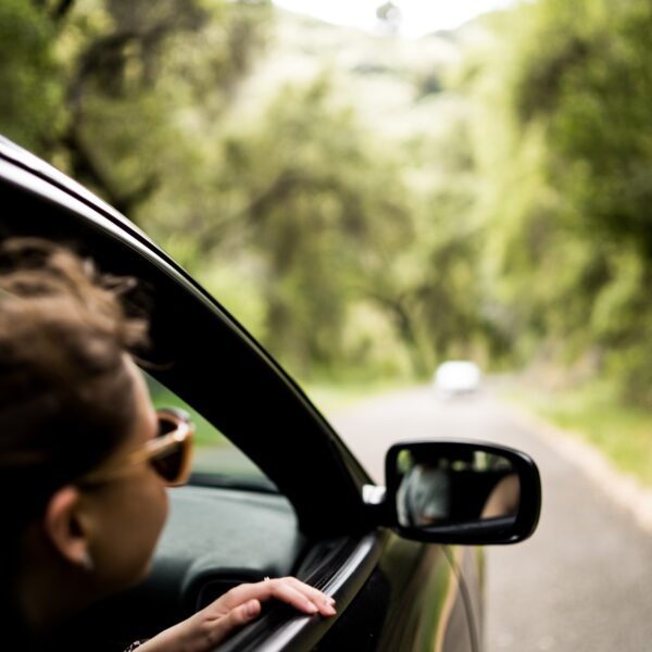 get your car ready for summer. Man looking outside of his car window
