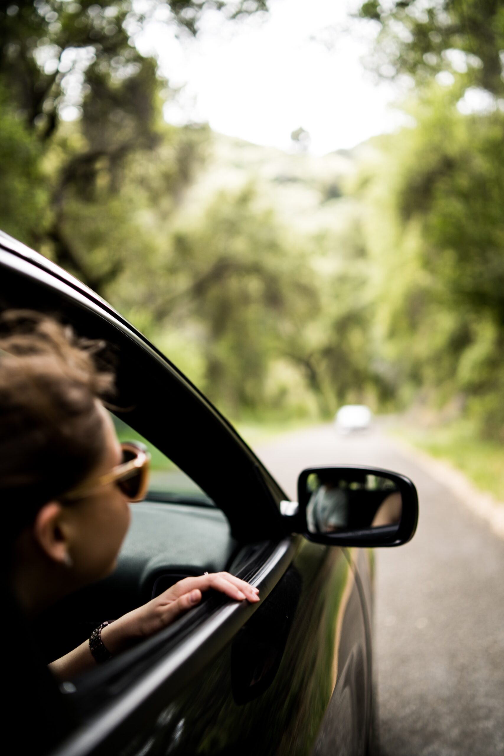 get your car ready for summer. Man looking outside of his car window