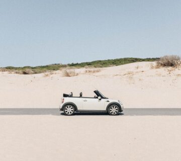 Getting Your Car Clean After A Trip To The Beach: white car sat on the beach