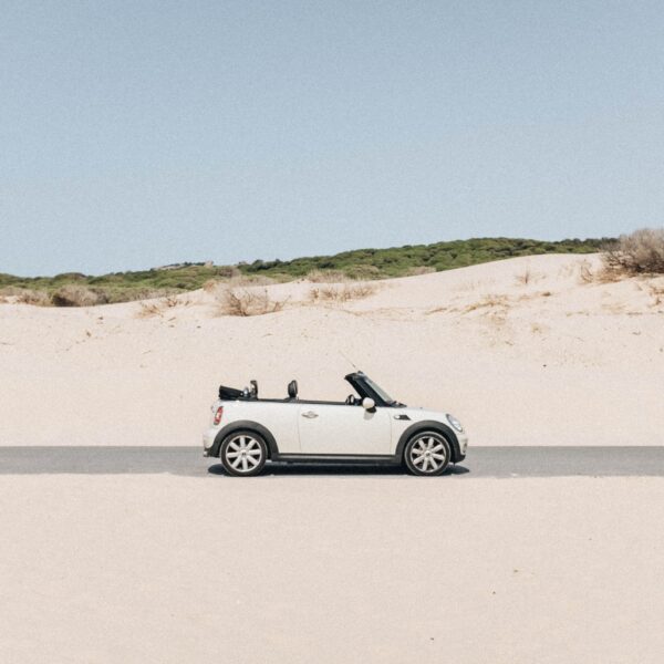 Getting Your Car Clean After A Trip To The Beach: white car sat on the beach