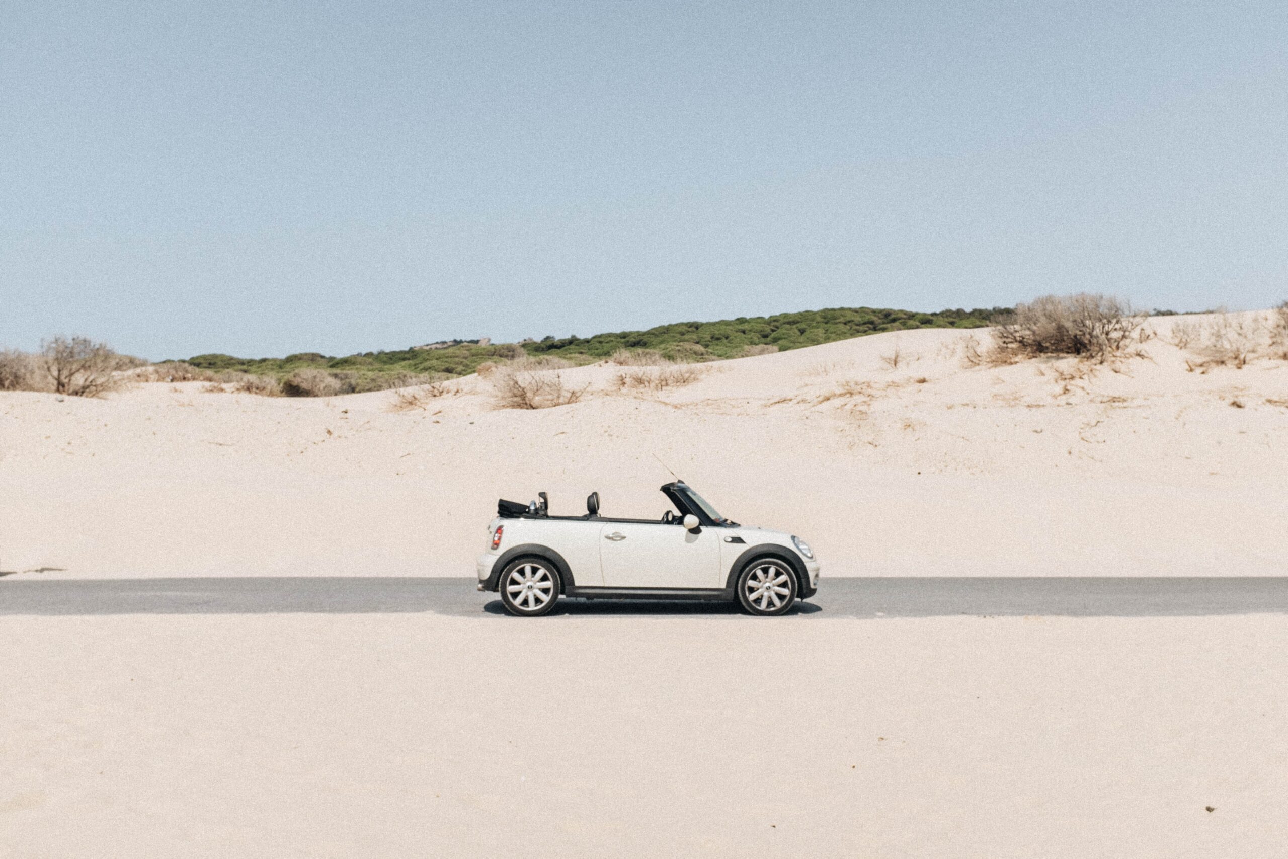 Getting Your Car Clean After A Trip To The Beach: white car sat on the beach