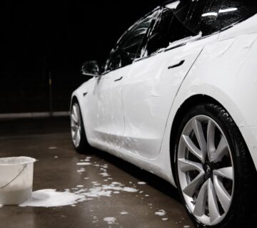 White car covered in soapy water