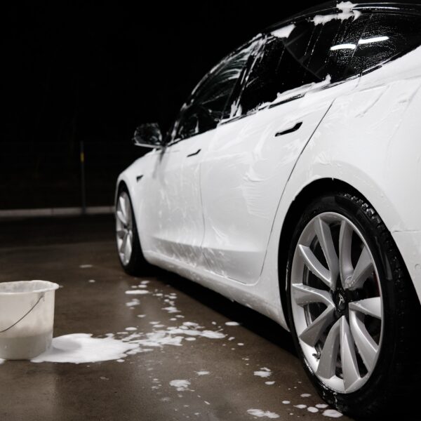 White car covered in soapy water